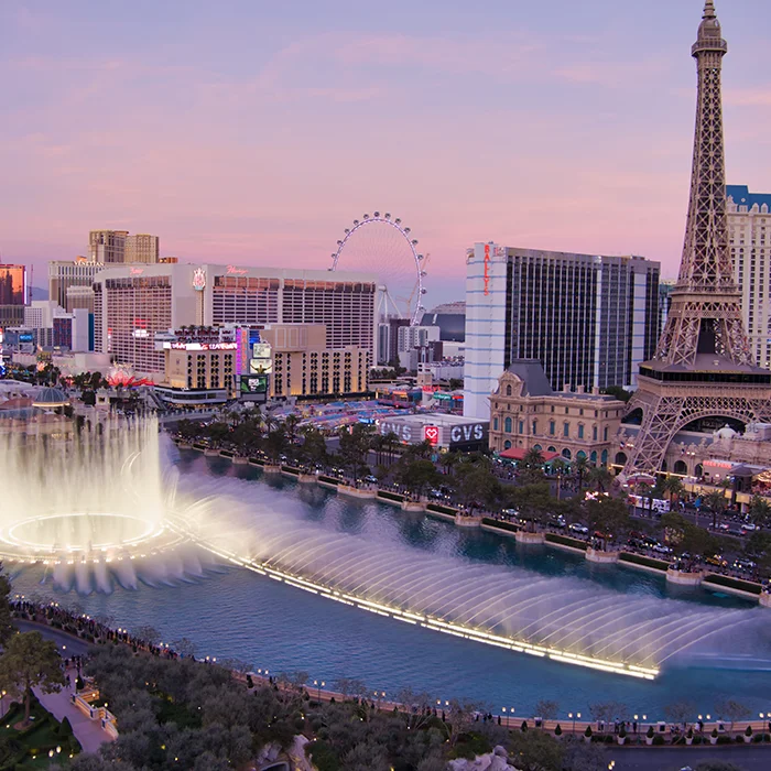 Las Vegas strip at dusk with the fountains and Paris tower
