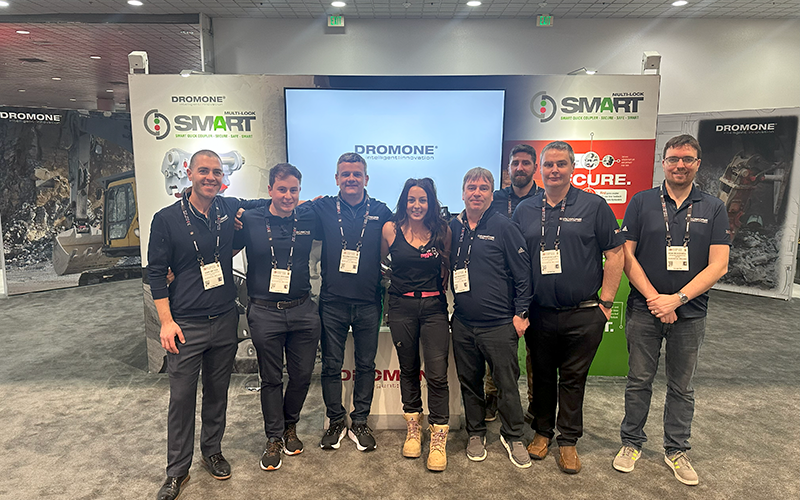 Amy posing with the DROMONE team at CONEXPO-CON/AGG