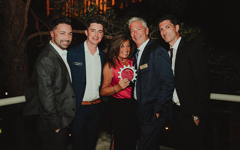 Matt Stanley and Family dressed up holding an award