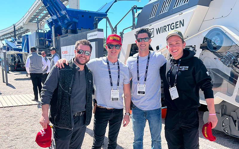 Matt Stanley and group posing for photo in front of Wirtgen equipment