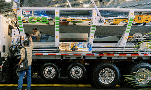 Guy looking at truck on CONEXPO-CON/AGG show floor