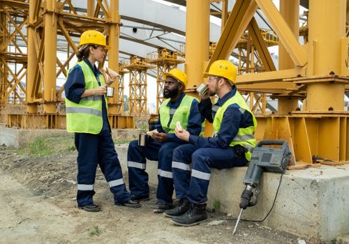 Construction workers sitting eating lunch