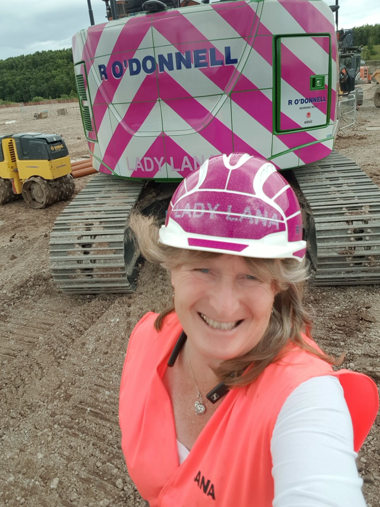 Lana Edwards with pink custom excavator with her nick name on it