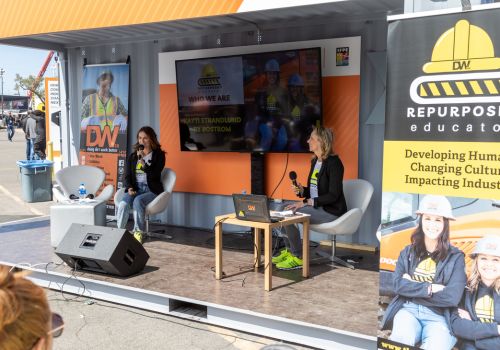 two women on stage presenting at the community zone at CONEXPO-CON/AGG 2023