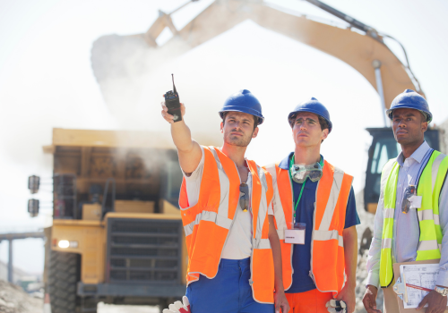 Workers and businessman standing in quarry