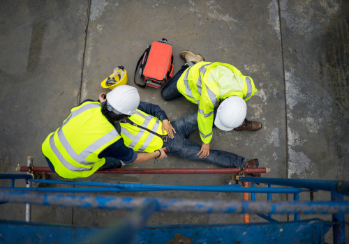 Builder injury accident falling scaffolding to the floor. Basic first aid training for support accident in site work, Safety team help employee accident.