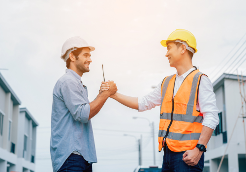 Portrait of Engineer construction workers shaking hands with deals on construction site, success collaboration concept, teamwork.