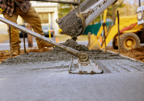 Worker working for concrete pavement for ground at construction