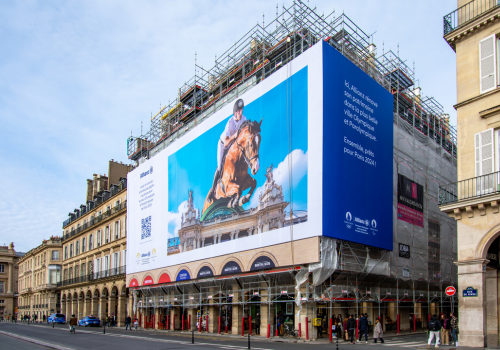 Paris, France - January 27, 2024: Giant advertising billboard sponsored by Allianz about the Paris 2024 Olympic games (show jumping) on the scaffoldings of the restoration work of a parisian building