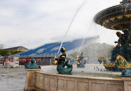 Paris, France :May 1'2024 - Concorde water fountain with grand stadium under the construction in background with sky, preparation for Paris 2024 Olympics.