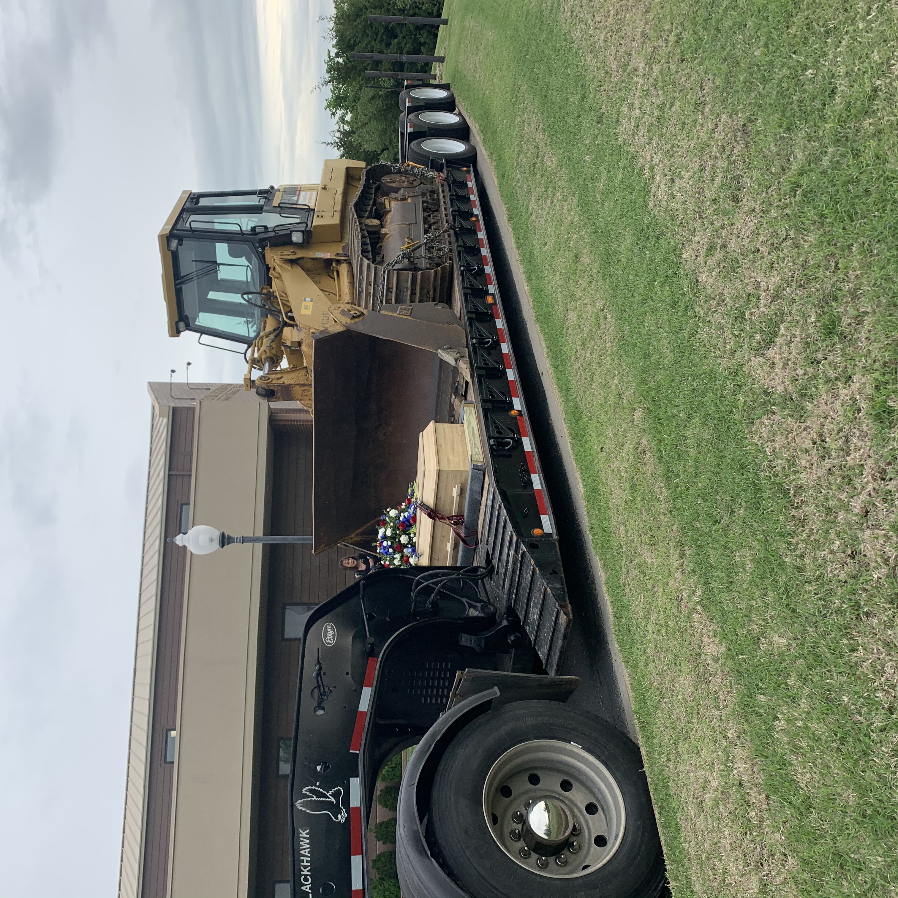 Terry Peeves, who, facing terminal illness, asked for “one more ride with his loader.” His casket was placed on a lowboy under that machine at his funeral.