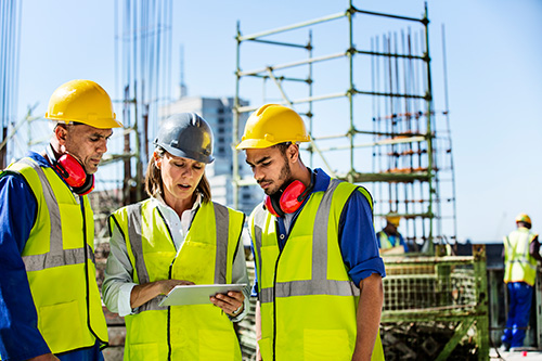 Construction workers looking at tablet