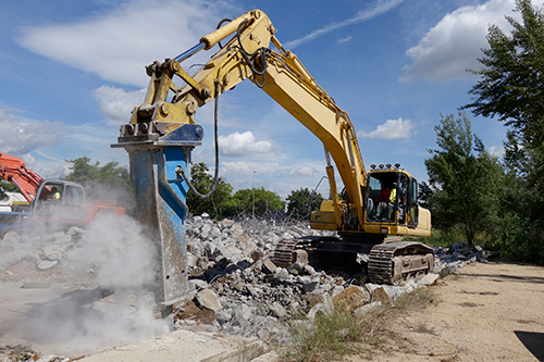 Excavator drilling concrete