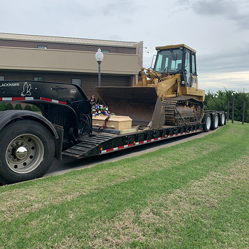 Terry Peeves, who, facing terminal illness, asked for “one more ride with his loader.” His casket was placed on a lowboy under that machine at his funeral.